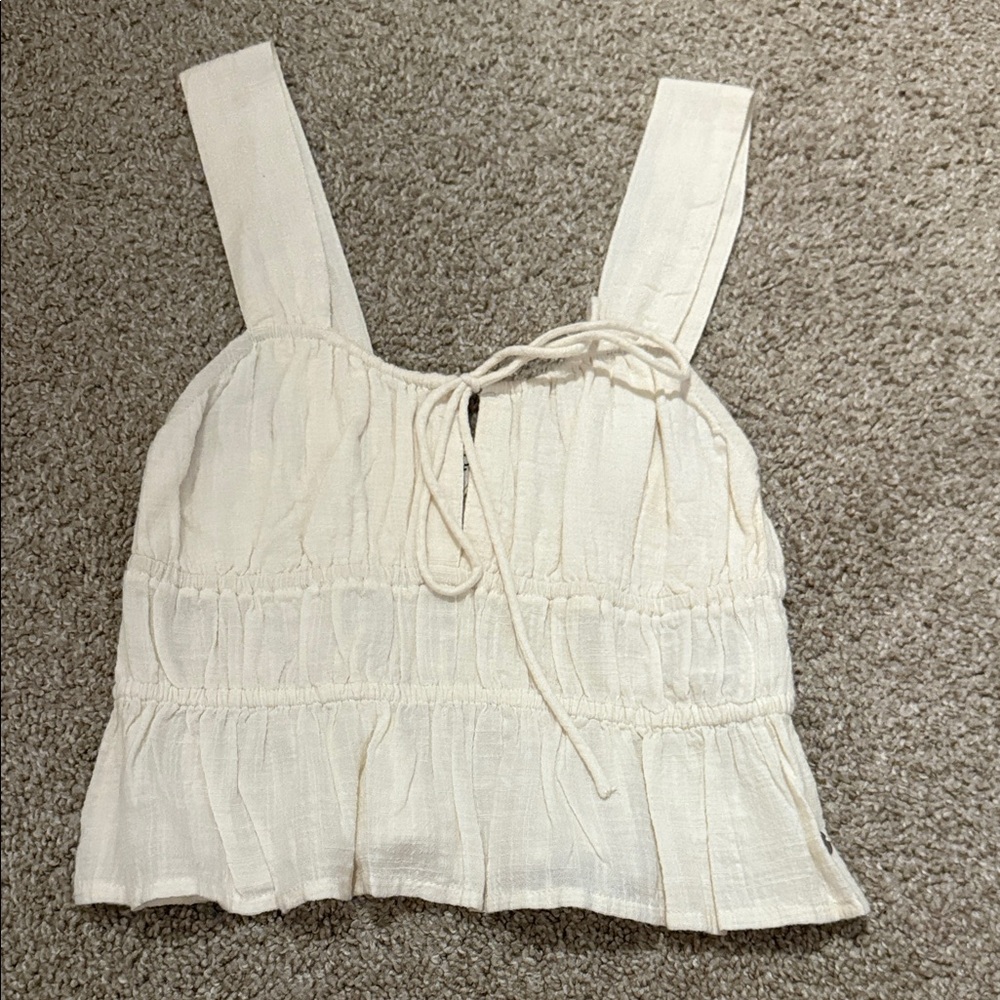 Roxy women’s cream colored ruffled tank top size x small. Never worn